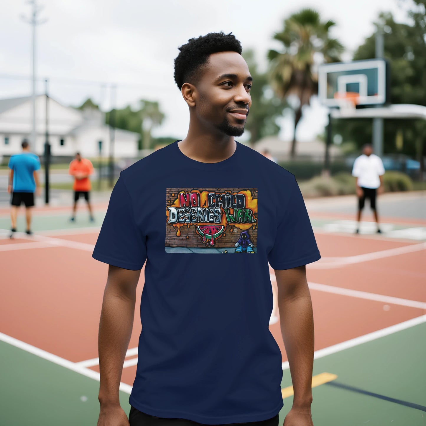 Man wearing a navy blue t-shirt with a colorful graphic on a basketball court