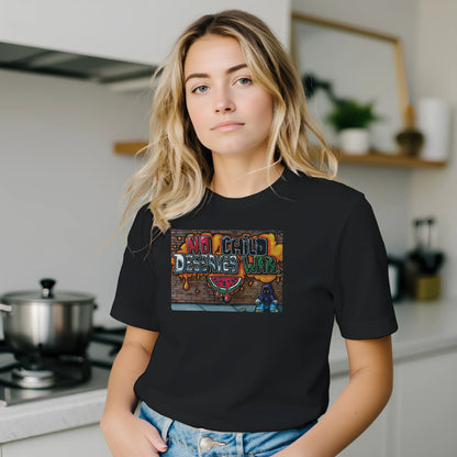 Person wearing a black t-shirt with a colorful graphic design in a kitchen setting